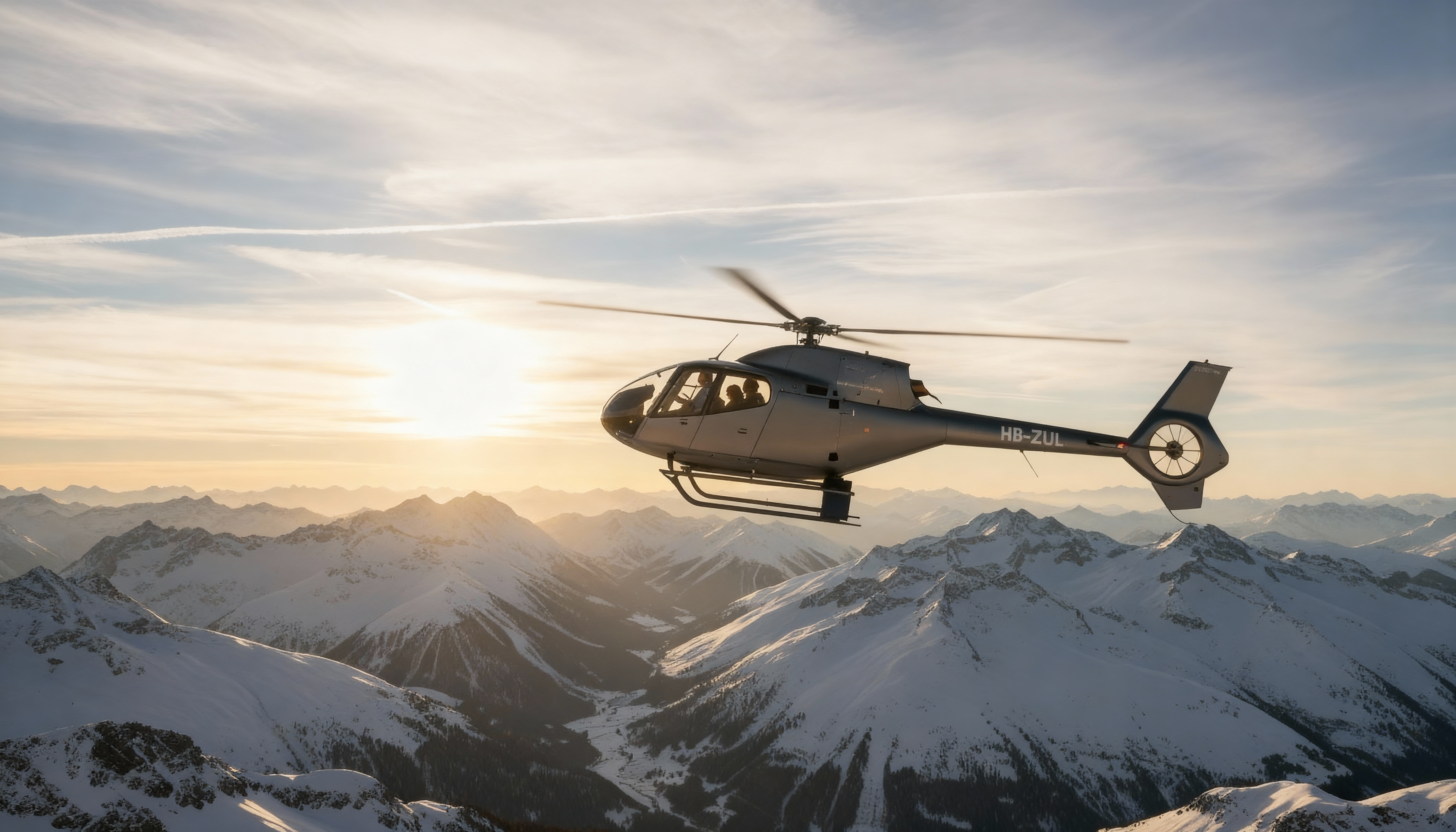 Helicopter EC120 flying to Davos in front of the Swiss Alps
